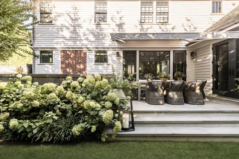 a view of a house with a yard and sitting area