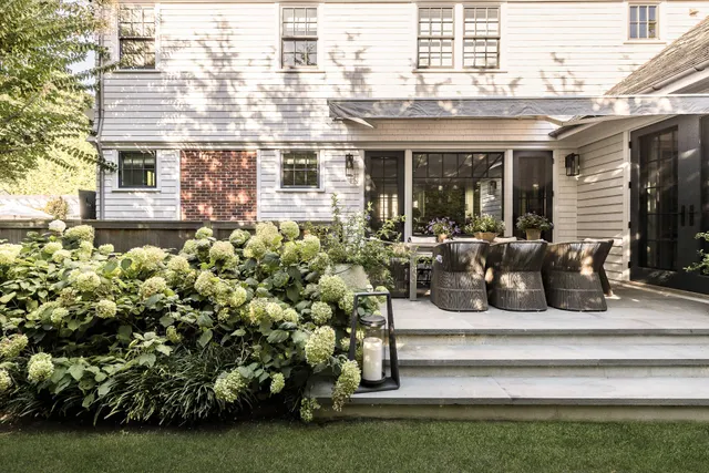 a view of a house with a yard and sitting area