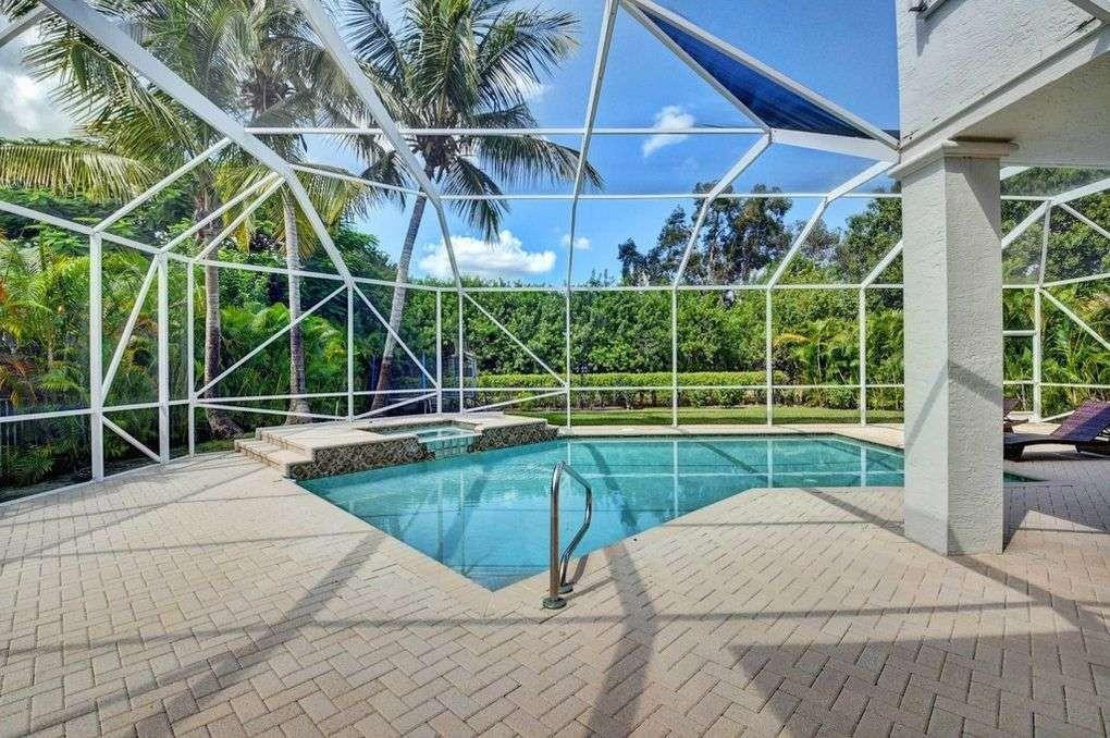 11119 Blue Coral Drive Boca Raton, FL 33498 - Photo 12 of 36 a view of a house with a swimming pool
