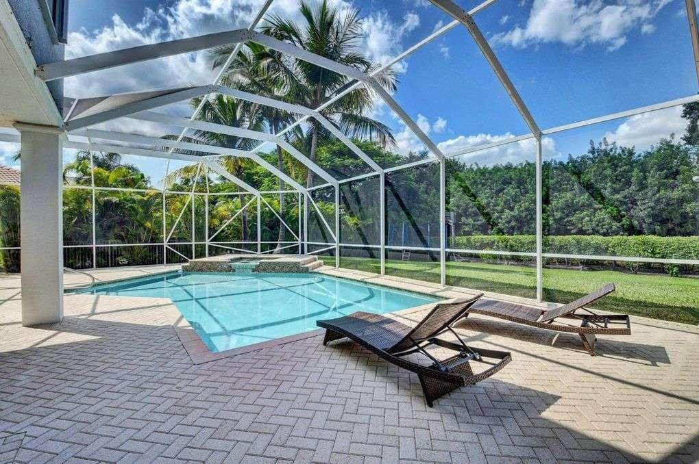 11119 Blue Coral Drive Boca Raton, FL 33498 - Photo 13 of 36 a view of a swimming pool with a lounge chairs