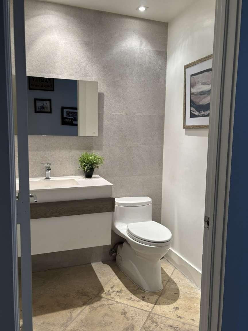 11119 Blue Coral Drive Boca Raton, FL 33498 - Photo 20 of 36 a bathroom with a sink toilet and mirror