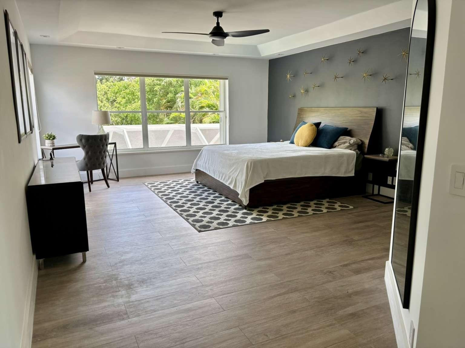 11119 Blue Coral Drive Boca Raton, FL 33498 - Photo 22 of 36 a bedroom with a bed and a table