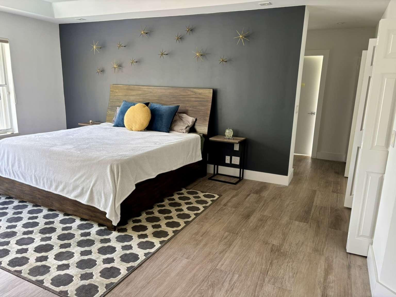 11119 Blue Coral Drive Boca Raton, FL 33498 - Photo 23 of 36 a bedroom with a bed and wooden floor