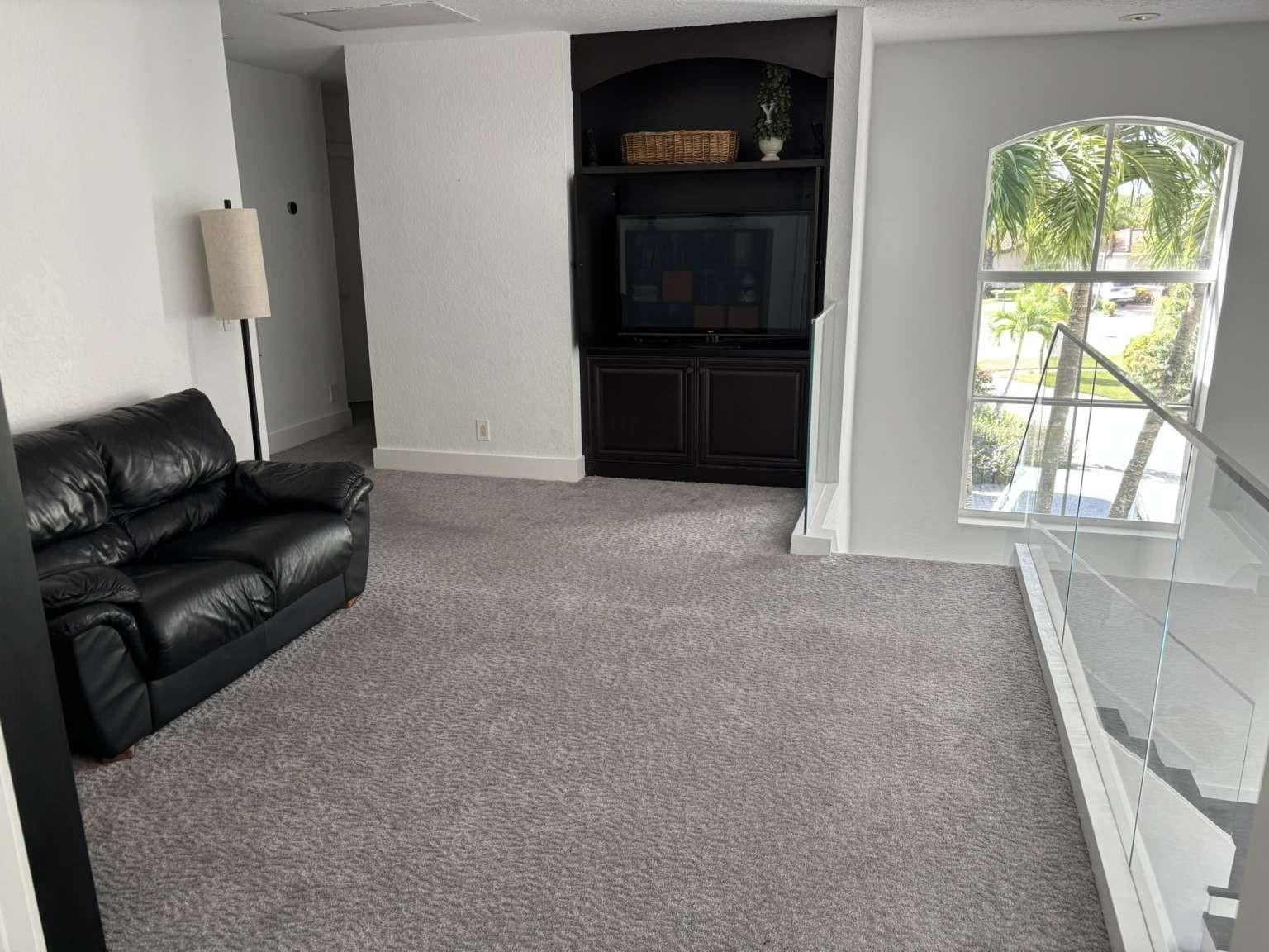 11119 Blue Coral Drive Boca Raton, FL 33498 - Photo 27 of 36 a living room with furniture and a flat screen tv