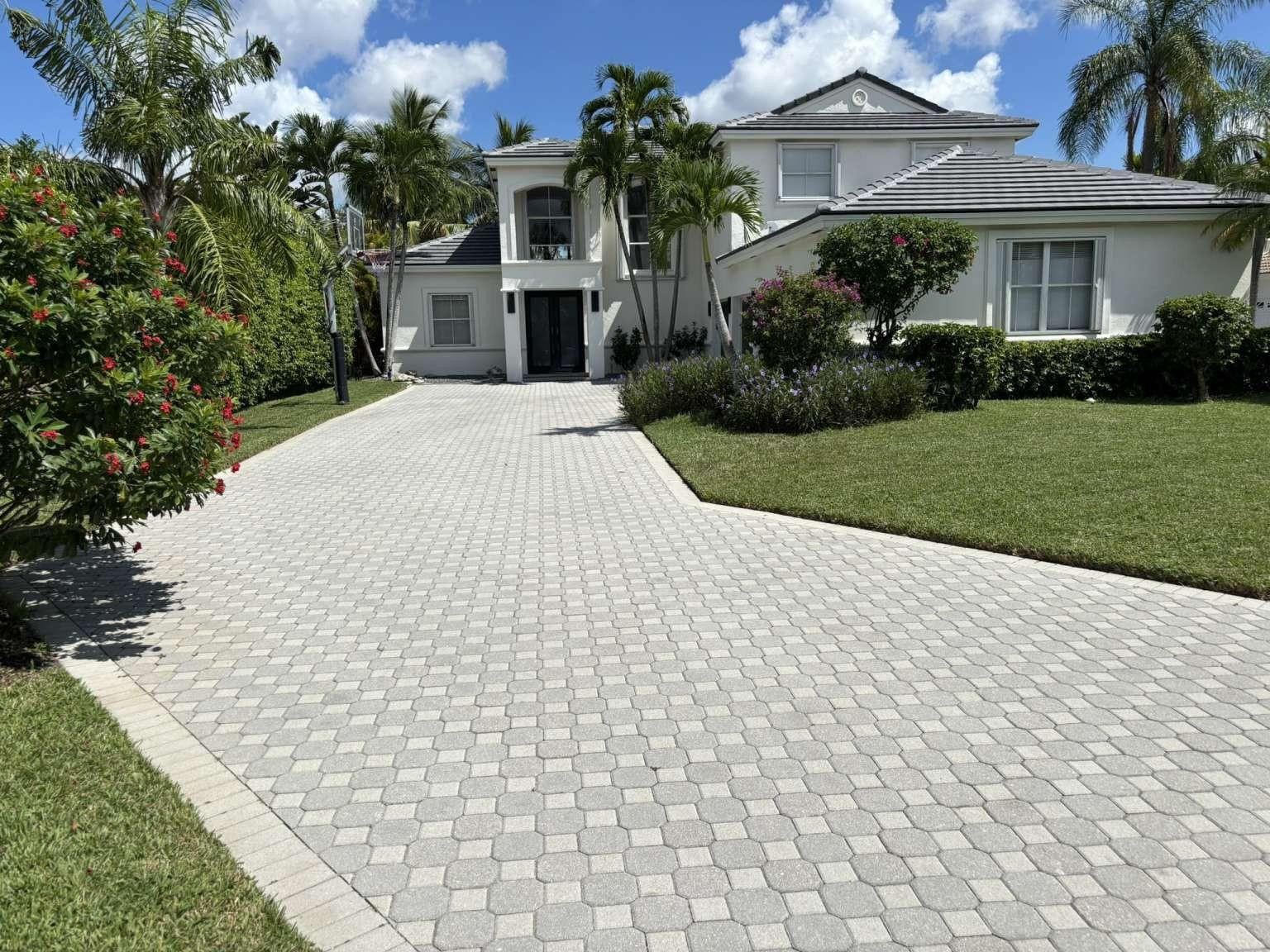 11119 Blue Coral Drive Boca Raton, FL 33498 - Photo 34 of 36 a view of a white house with a yard and potted plants