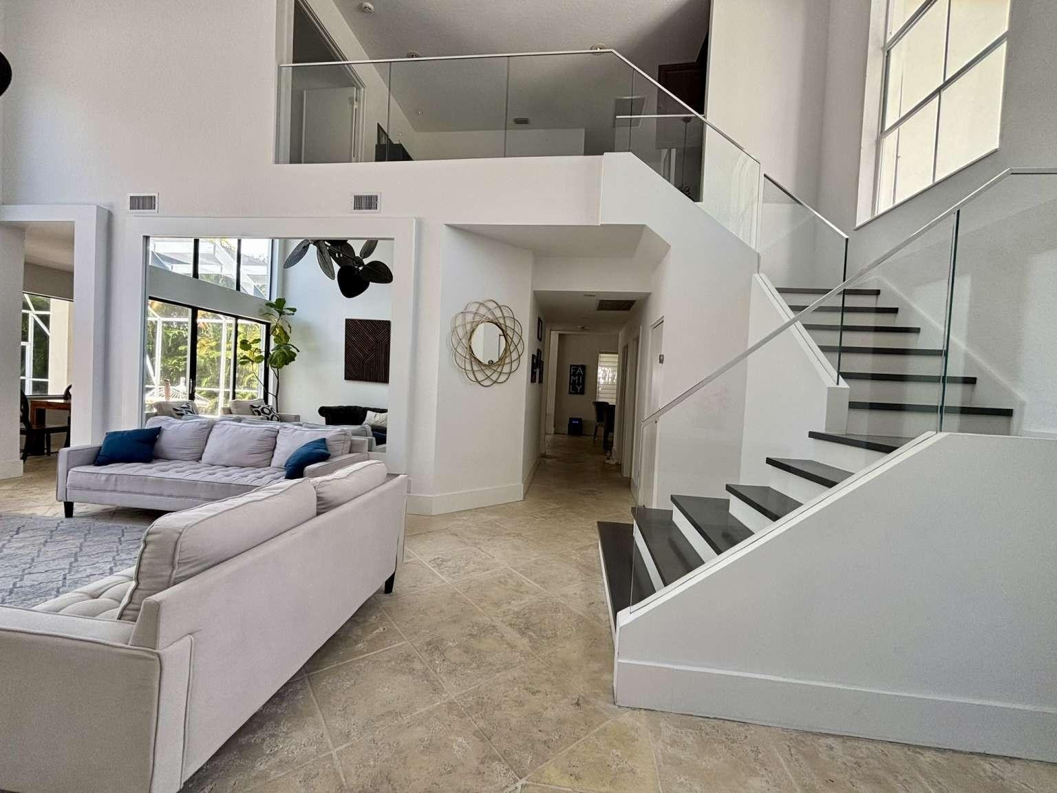 11119 Blue Coral Drive Boca Raton, FL 33498 - Photo 8 of 36 a living room with couches and kitchen view with wooden floor