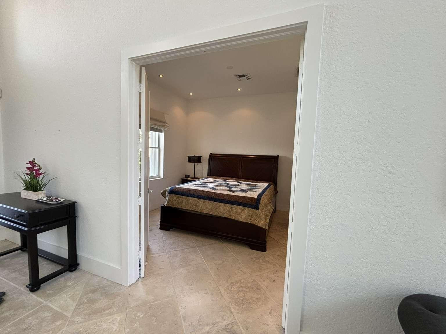 11119 Blue Coral Drive Boca Raton, FL 33498 - Photo 9 of 36 a bedroom with a bed and a dresser in it