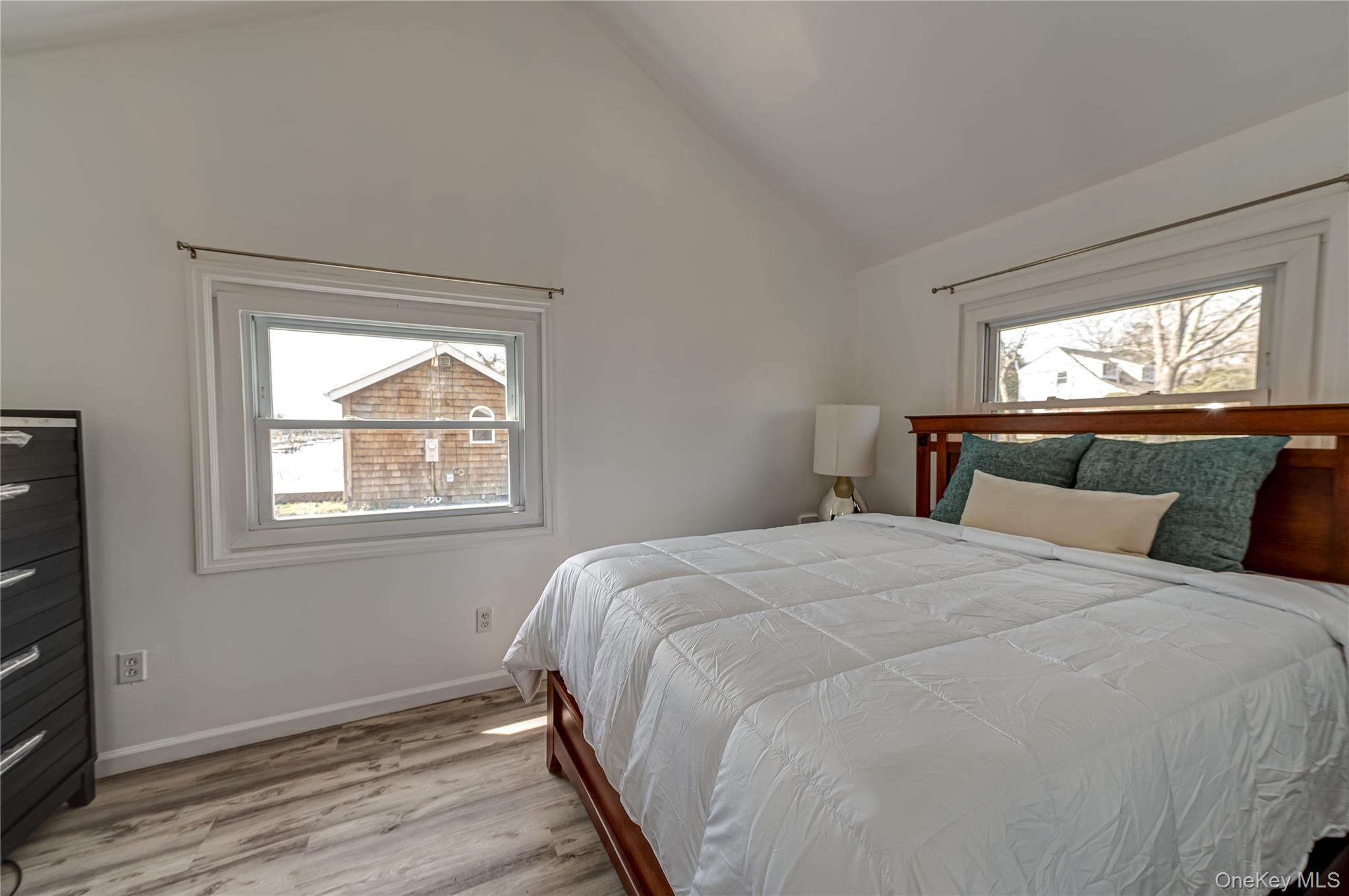 18 Shinnecock Road, Unit 3 Hampton Bays, NY 11946 - Photo 7 of 8 a bedroom with a bed and window