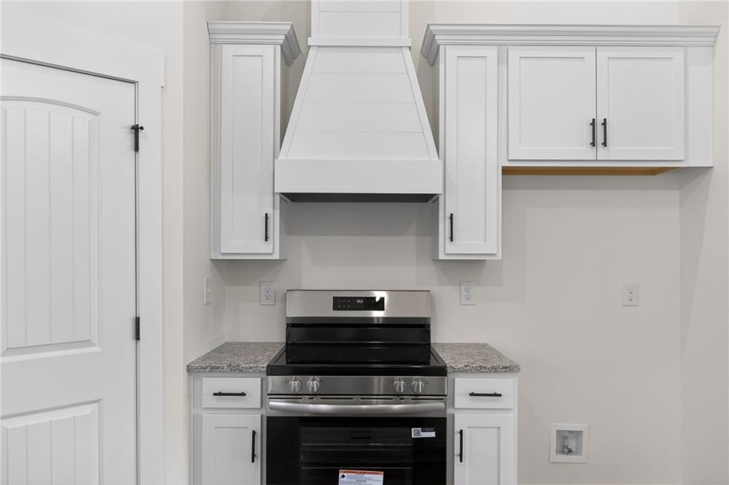 3512 Vinson Mountain Road Rockmart, GA 30153 - Photo 22 of 51 a kitchen with granite countertop a sink a stove and cabinets
