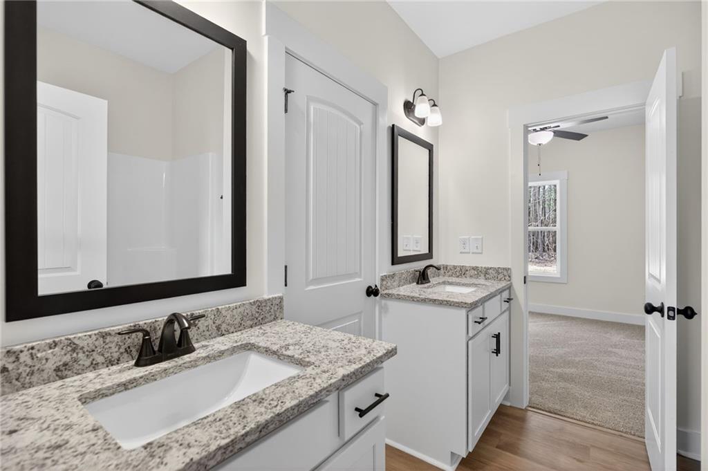 3512 Vinson Mountain Road Rockmart, GA 30153 - Photo 37 of 51 a bathroom with a granite countertop sink and a mirror