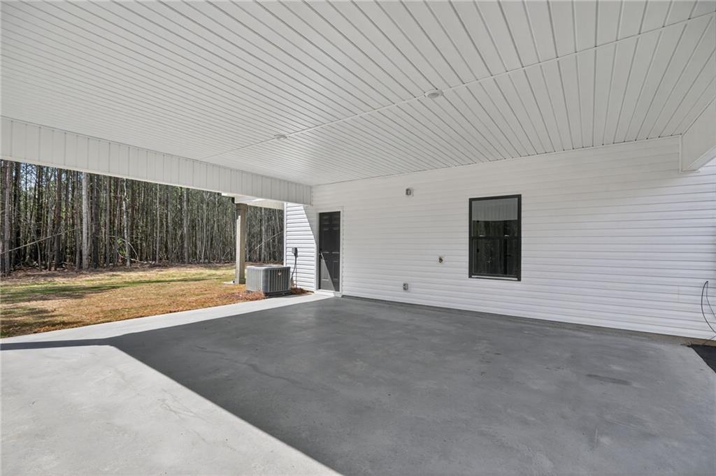 3512 Vinson Mountain Road Rockmart, GA 30153 - Photo 44 of 51 a view of an empty room with wooden floor and a fireplace