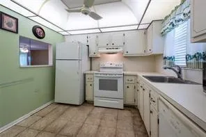 a kitchen with a stove top oven cabinets and a refrigerator