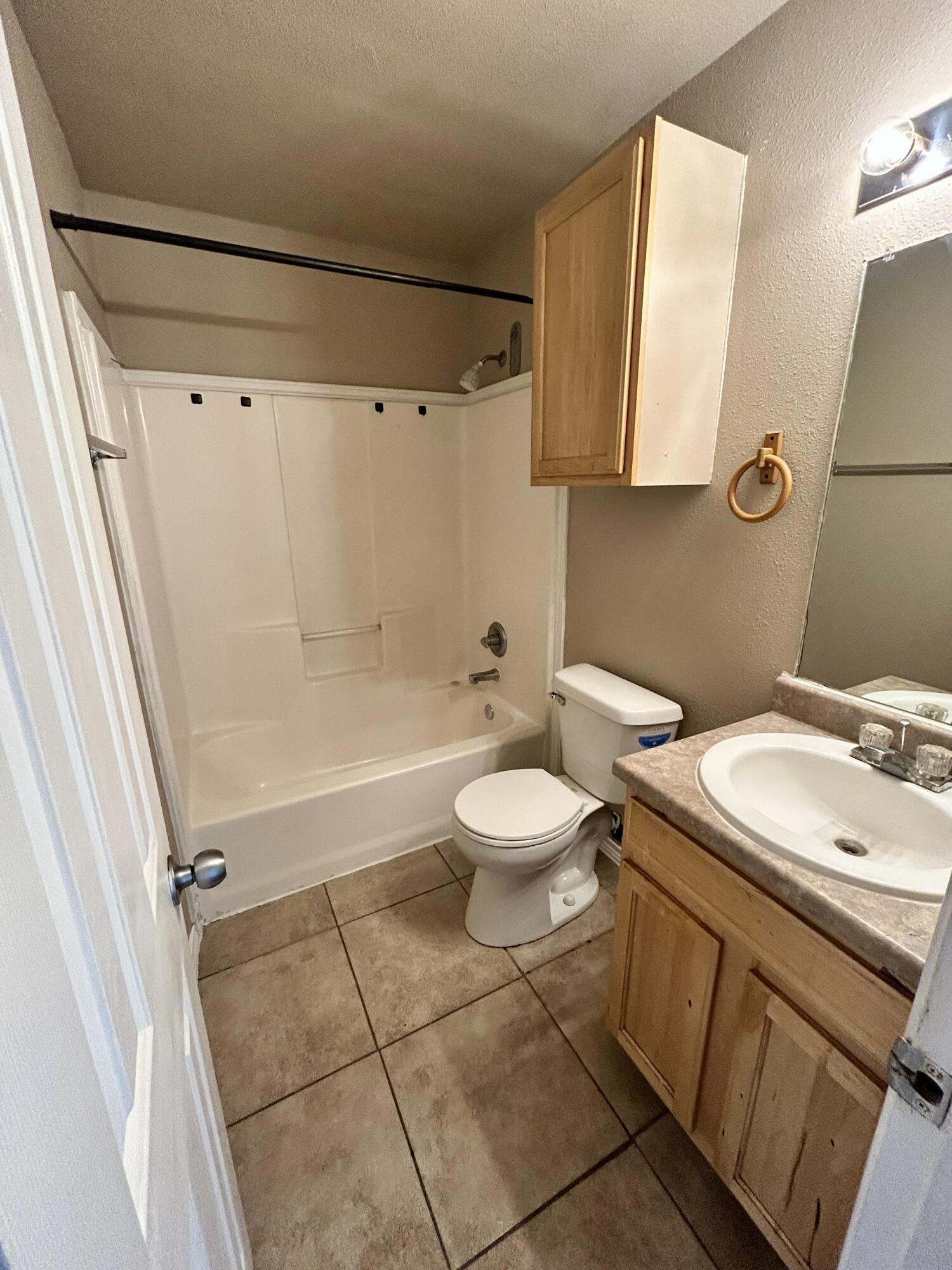 715 43rd Street, Unit 1&2 Lubbock, TX 79404 - Photo 12 of 13 a bathroom with a sink a toilet and shower