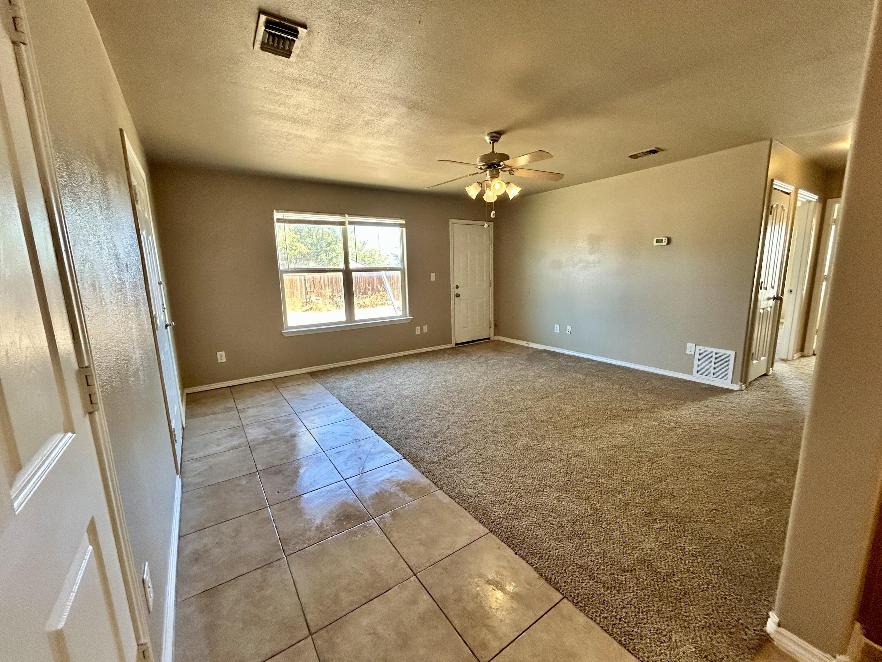 715 43rd Street, Unit 1&2 Lubbock, TX 79404 - Photo 8 of 13 an empty room with windows and fan