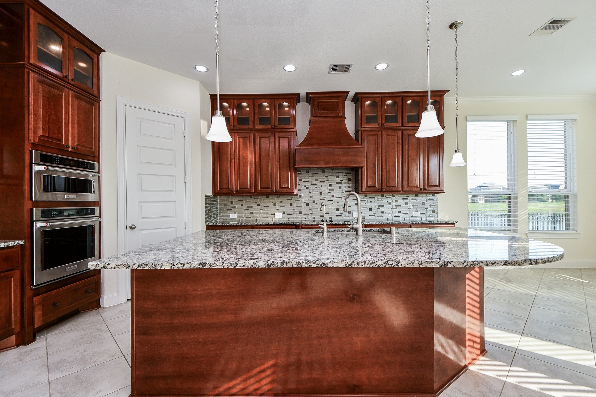 3618 Meandering Spring Drive Katy, TX 77494 - Photo 11 of 50 a kitchen with kitchen island granite countertop wooden cabinets and a granite counter tops