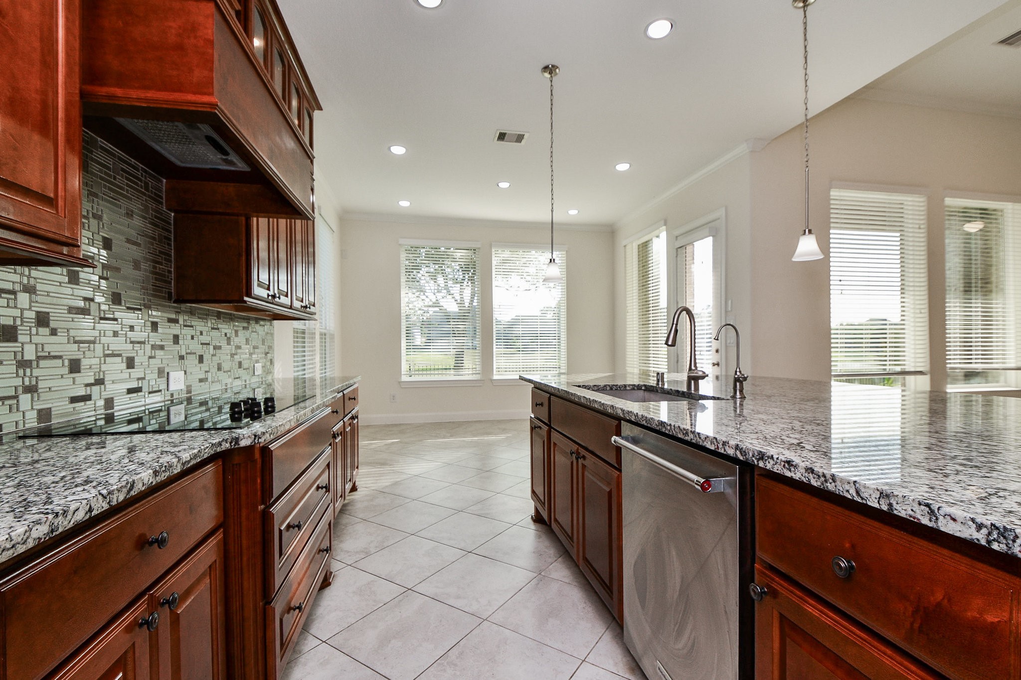 3618 Meandering Spring Drive Katy, TX 77494 - Photo 12 of 50 a kitchen with stainless steel appliances granite countertop sink stove and cabinets