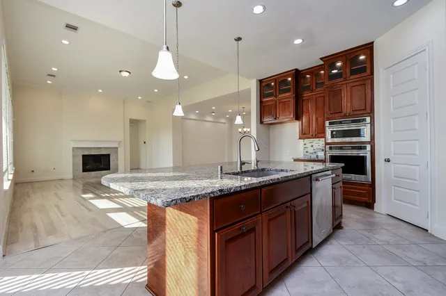 a kitchen with stainless steel appliances granite countertop sink stove and cabinets