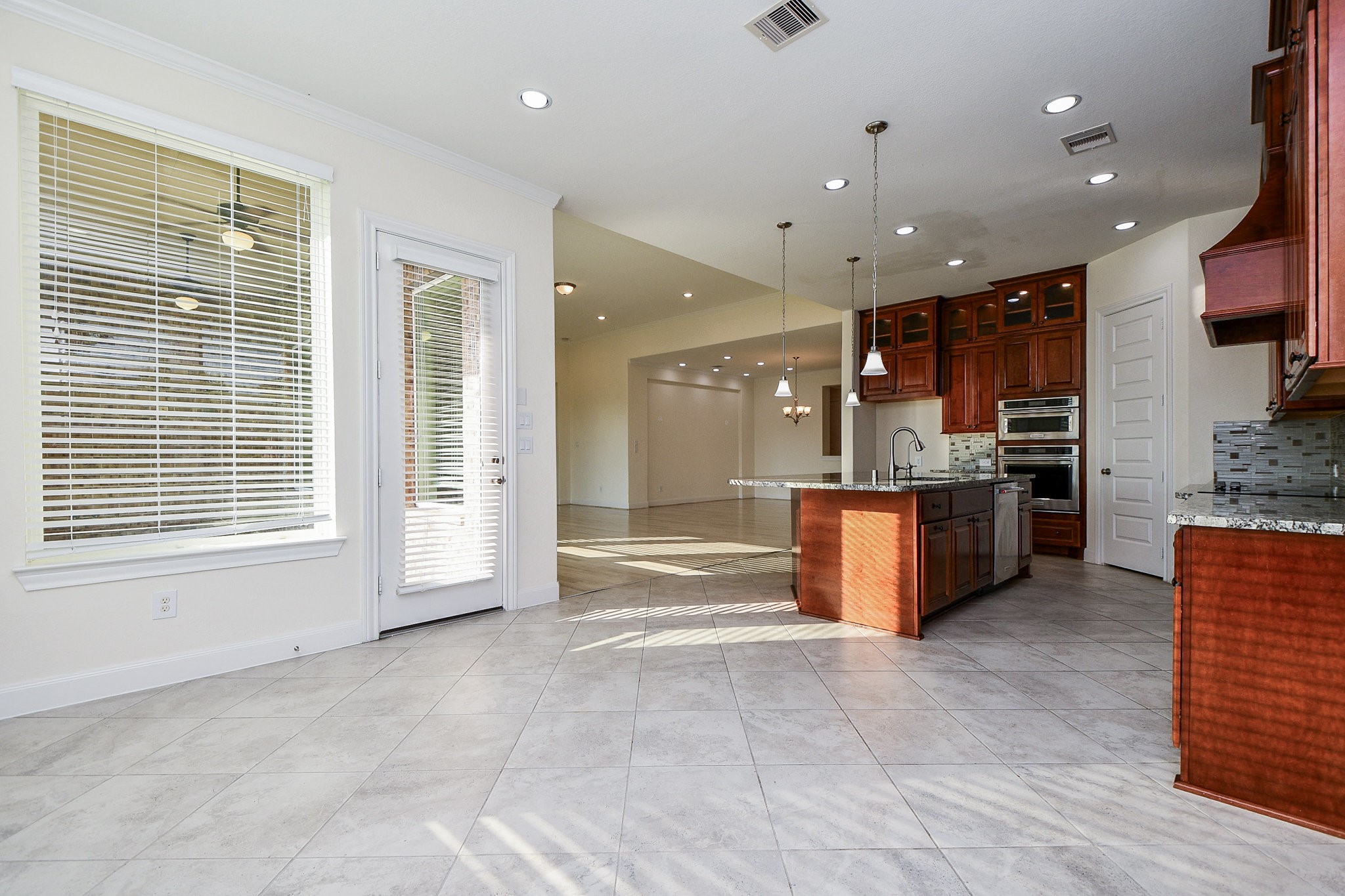 3618 Meandering Spring Drive Katy, TX 77494 - Photo 17 of 50 a large kitchen with stainless steel appliances kitchen island granite countertop a large counter top and a stove