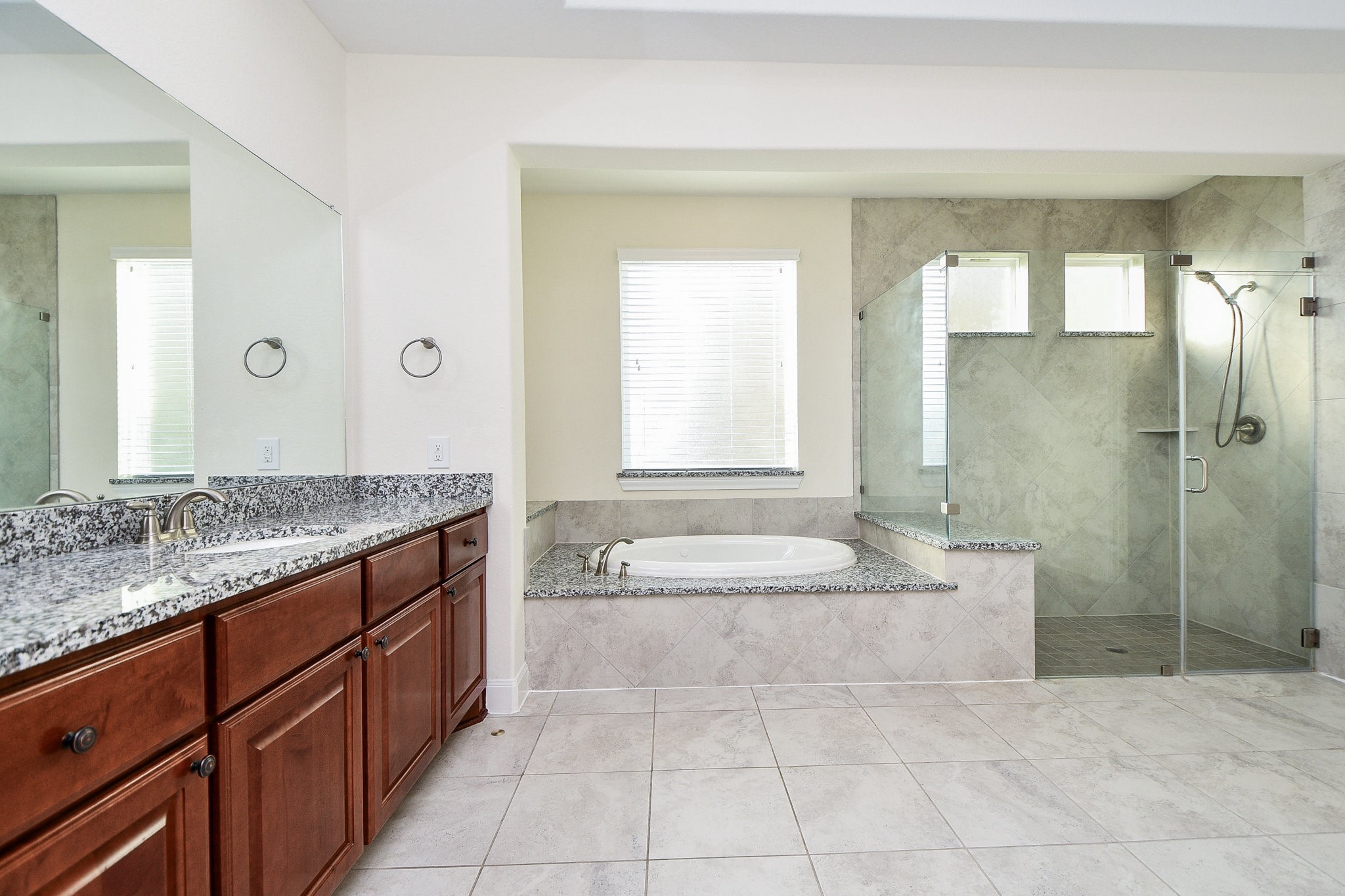 3618 Meandering Spring Drive Katy, TX 77494 - Photo 26 of 50 a spacious bathroom with a granite countertop tub sink and mirror
