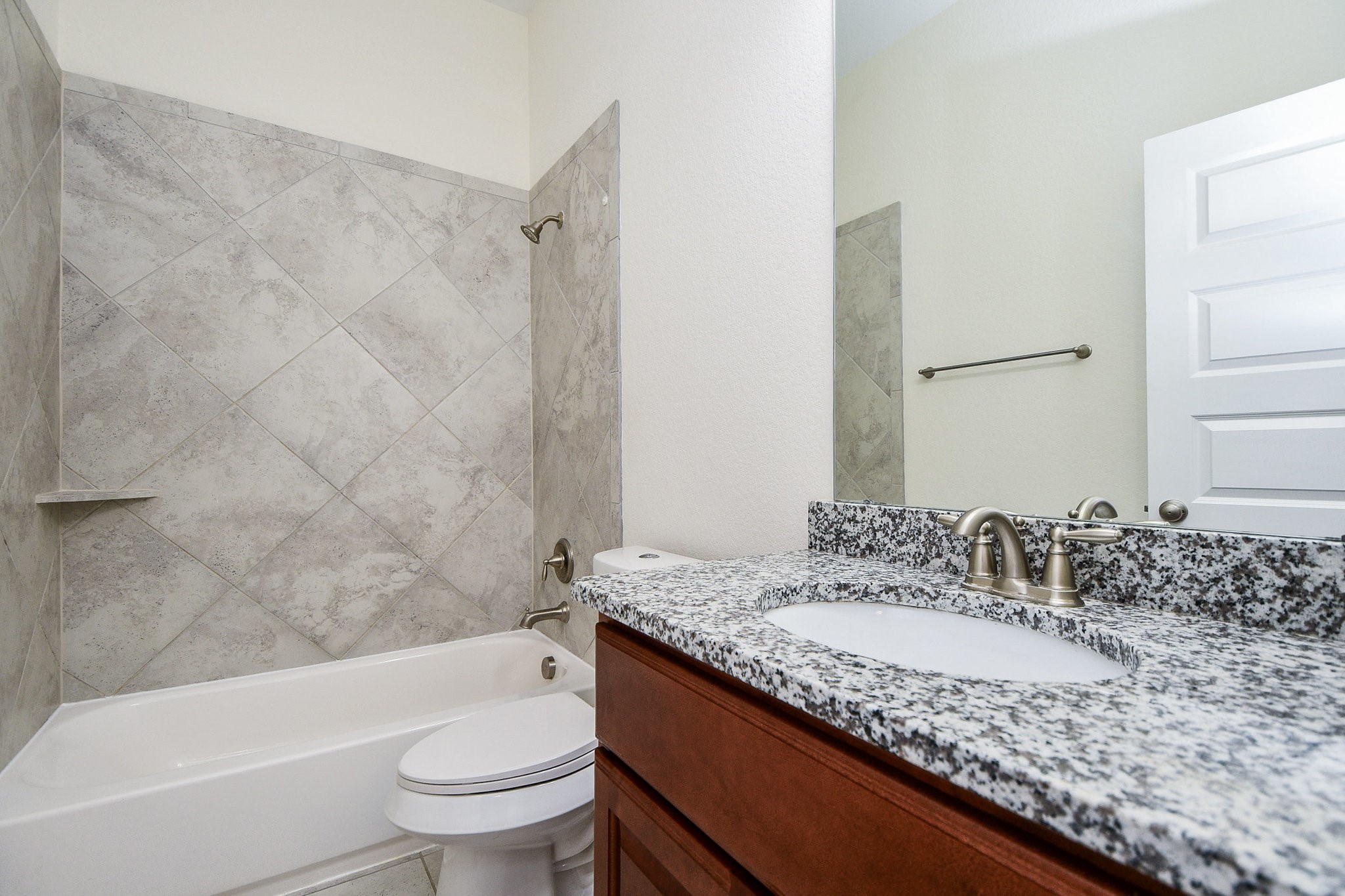 3618 Meandering Spring Drive Katy, TX 77494 - Photo 34 of 50 a bathroom with a granite countertop sink a toilet a mirror a bathtub and shower