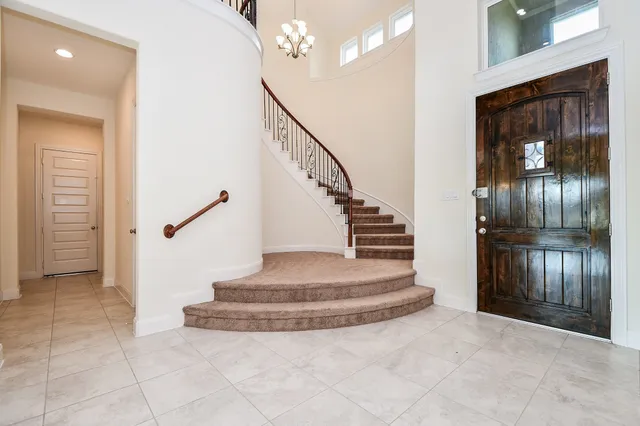 a view of entryway and hall with a front door