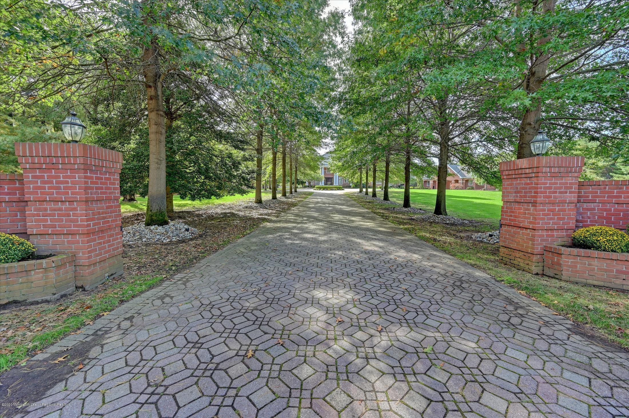 1 Laredo Drive Colts Neck, NJ 07722 - Photo 12 of 78 a view of a backyard with large trees and plants