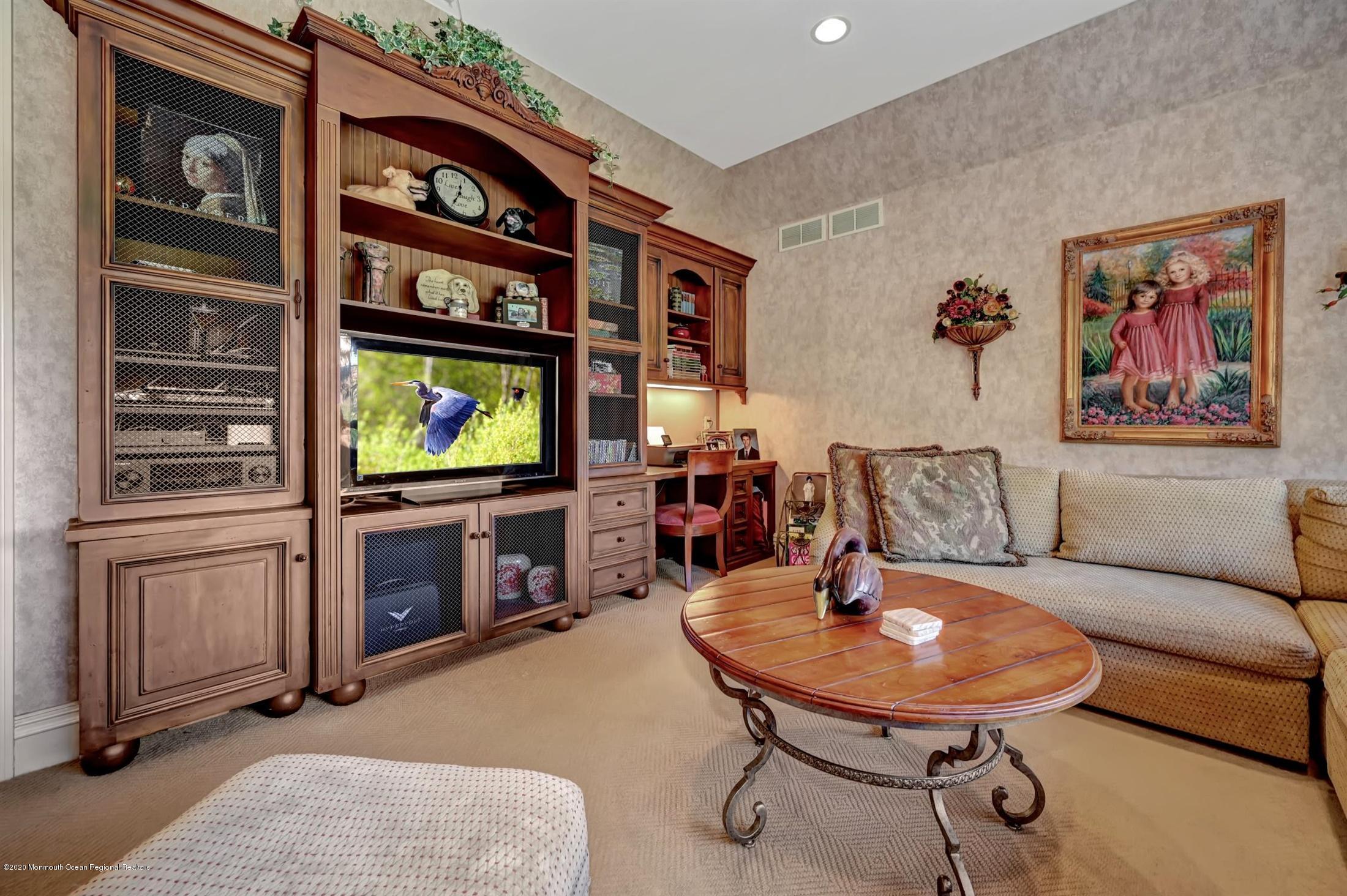 1 Laredo Drive Colts Neck, NJ 07722 - Photo 18 of 78 a living room with furniture a flat screen tv and kitchen view
