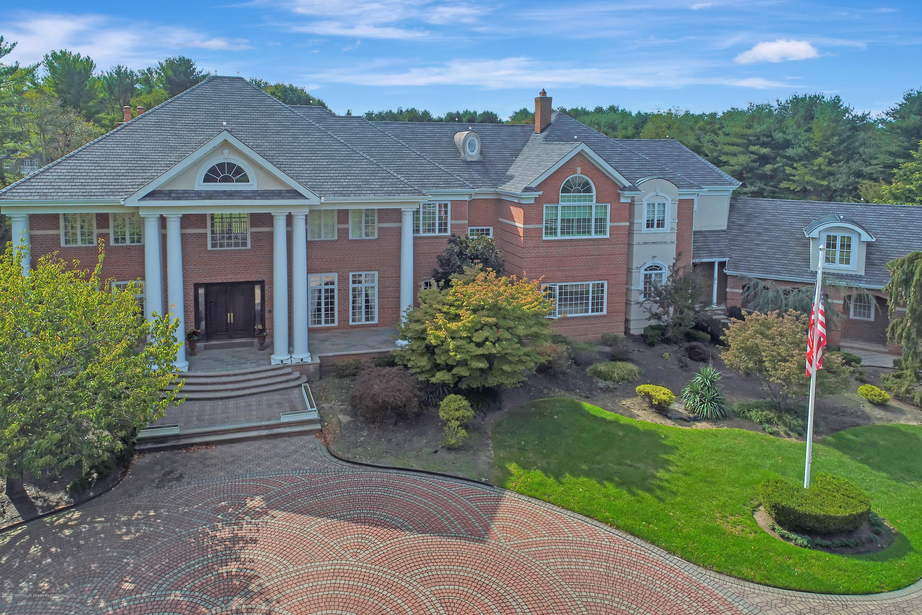 1 Laredo Drive Colts Neck, NJ 07722 - Photo 3 of 78 a front view of a house with a yard