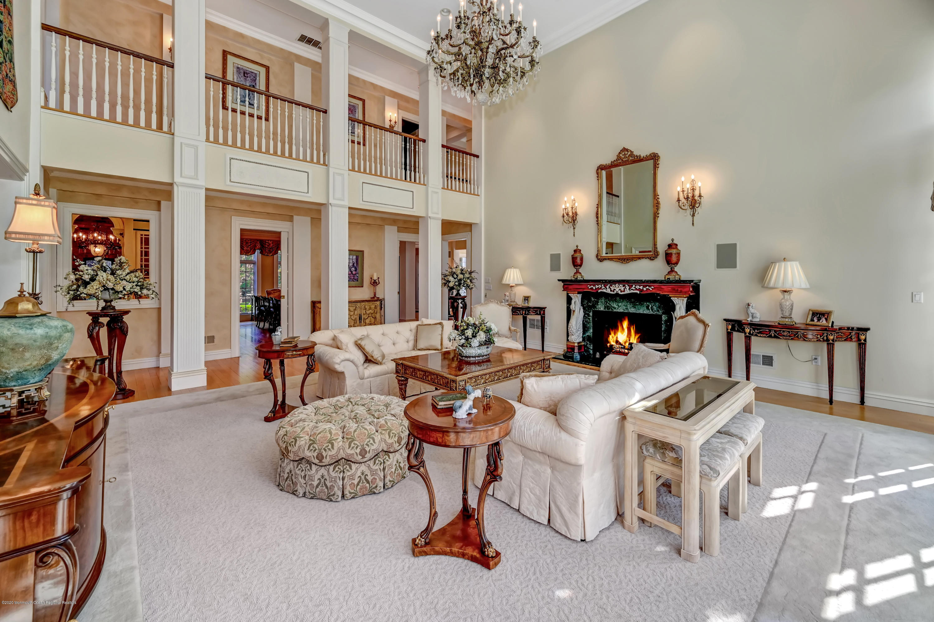 1 Laredo Drive Colts Neck, NJ 07722 - Photo 21 of 78 a living room with furniture a chandelier and a fireplace