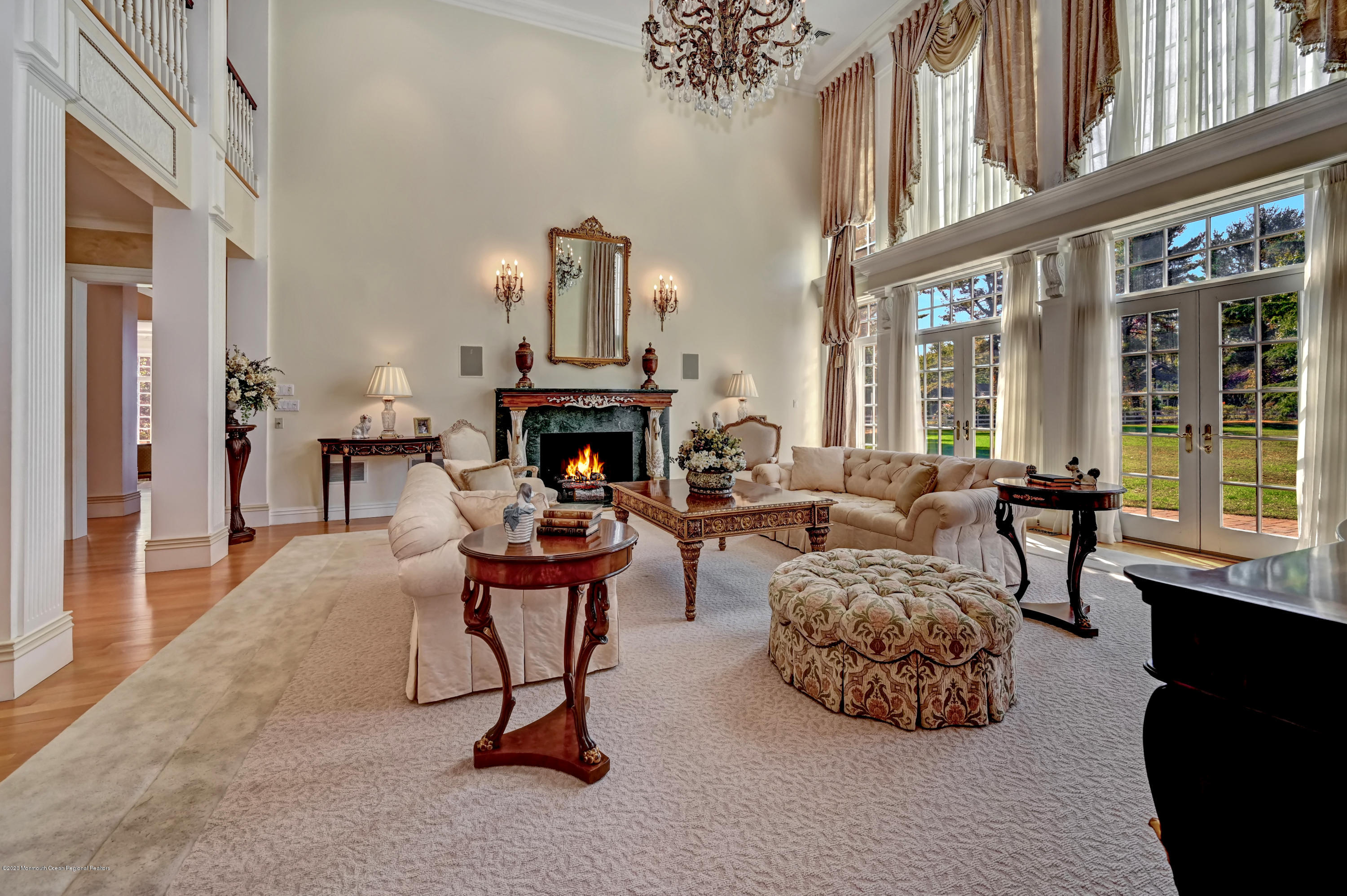 1 Laredo Drive Colts Neck, NJ 07722 - Photo 22 of 78 a living room with furniture a fireplace and a floor to ceiling window