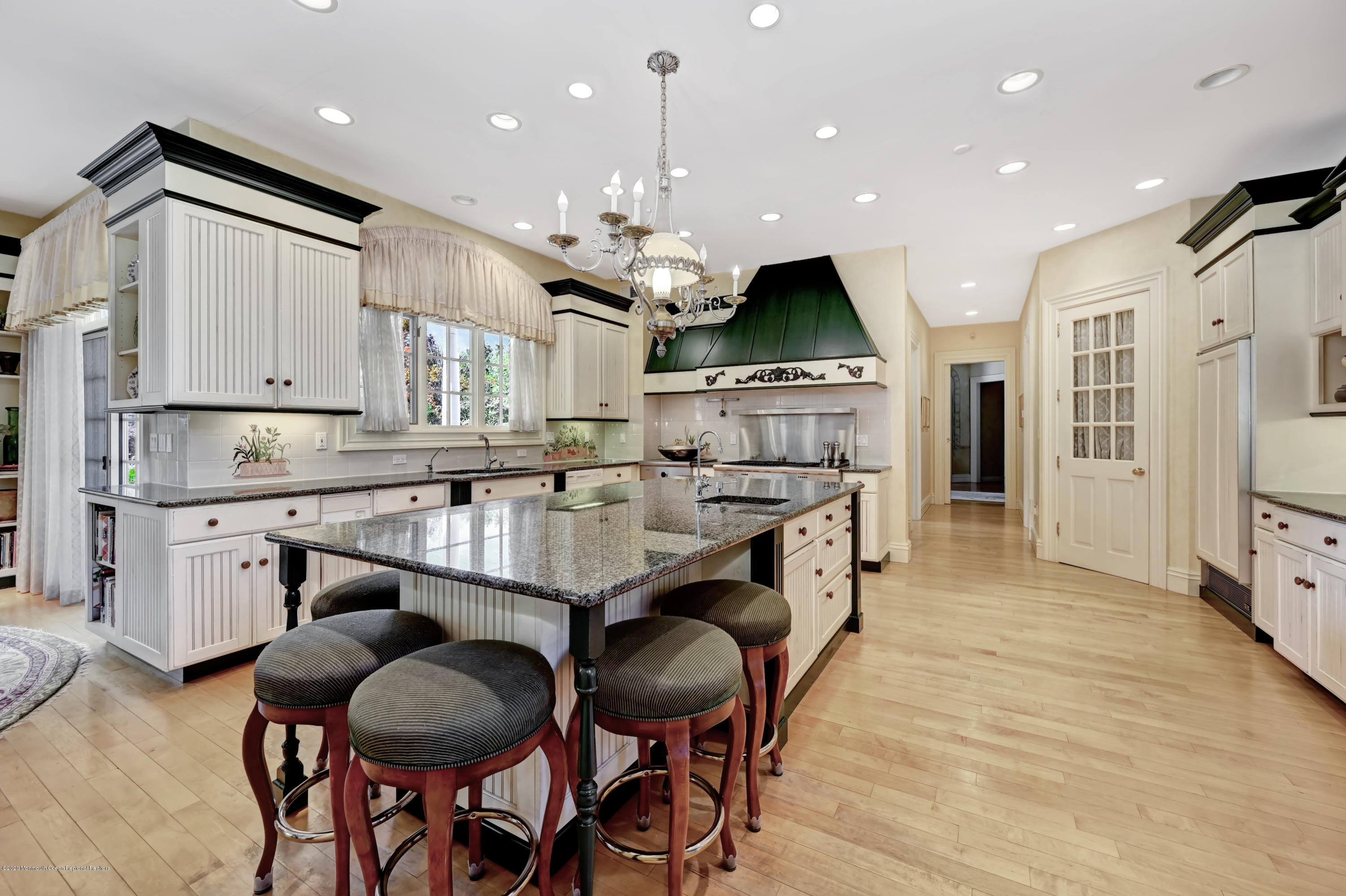 1 Laredo Drive Colts Neck, NJ 07722 - Photo 24 of 78 a kitchen with stainless steel appliances kitchen island granite countertop a table chairs sink and cabinets