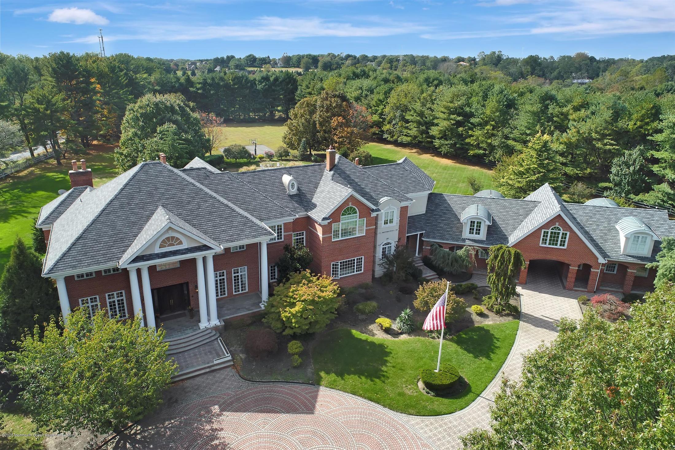 1 Laredo Drive Colts Neck, NJ 07722 - Photo 4 of 78 a aerial view of a house with a yard and large tree