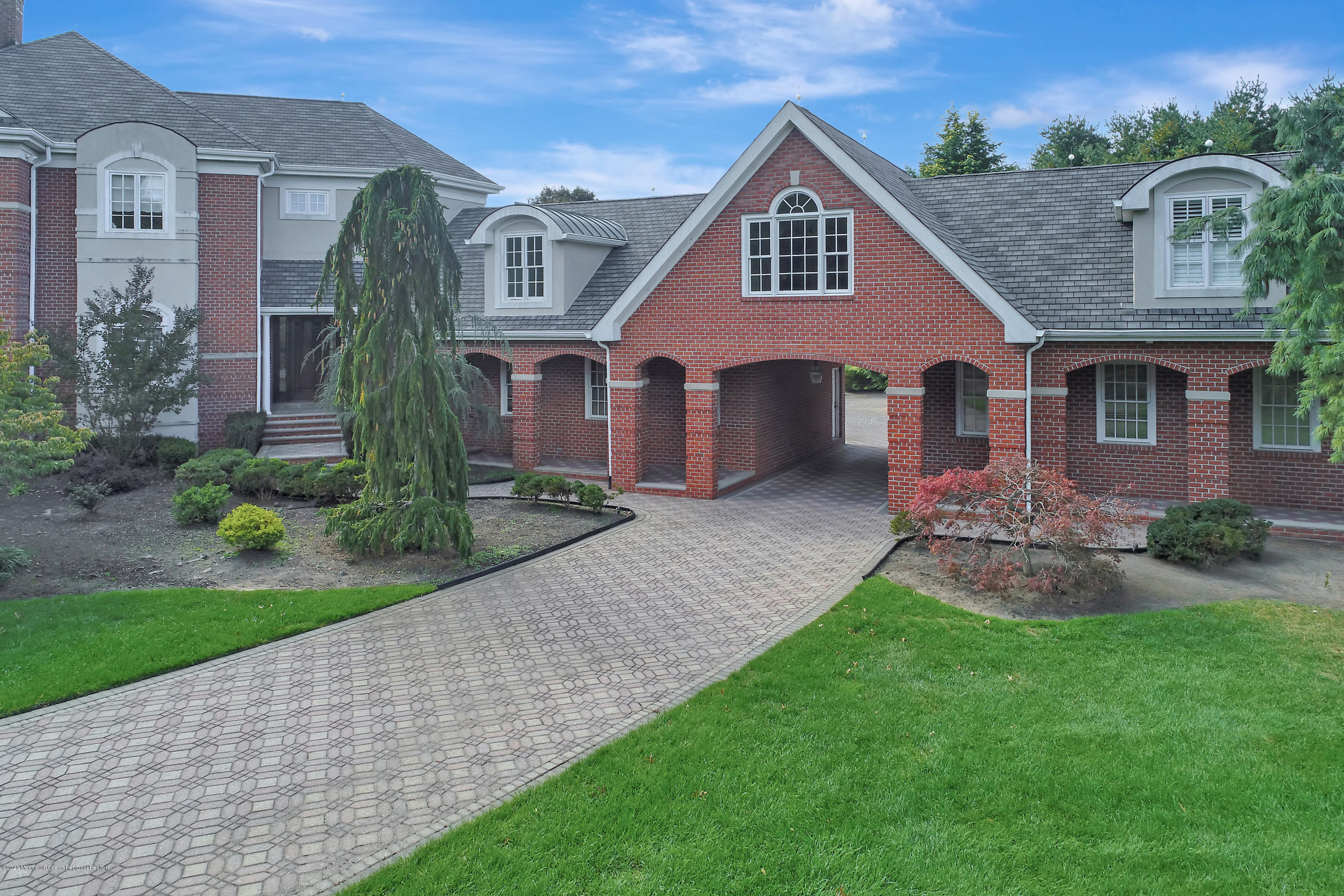 1 Laredo Drive Colts Neck, NJ 07722 - Photo 5 of 78 a front view of a house with a yard
