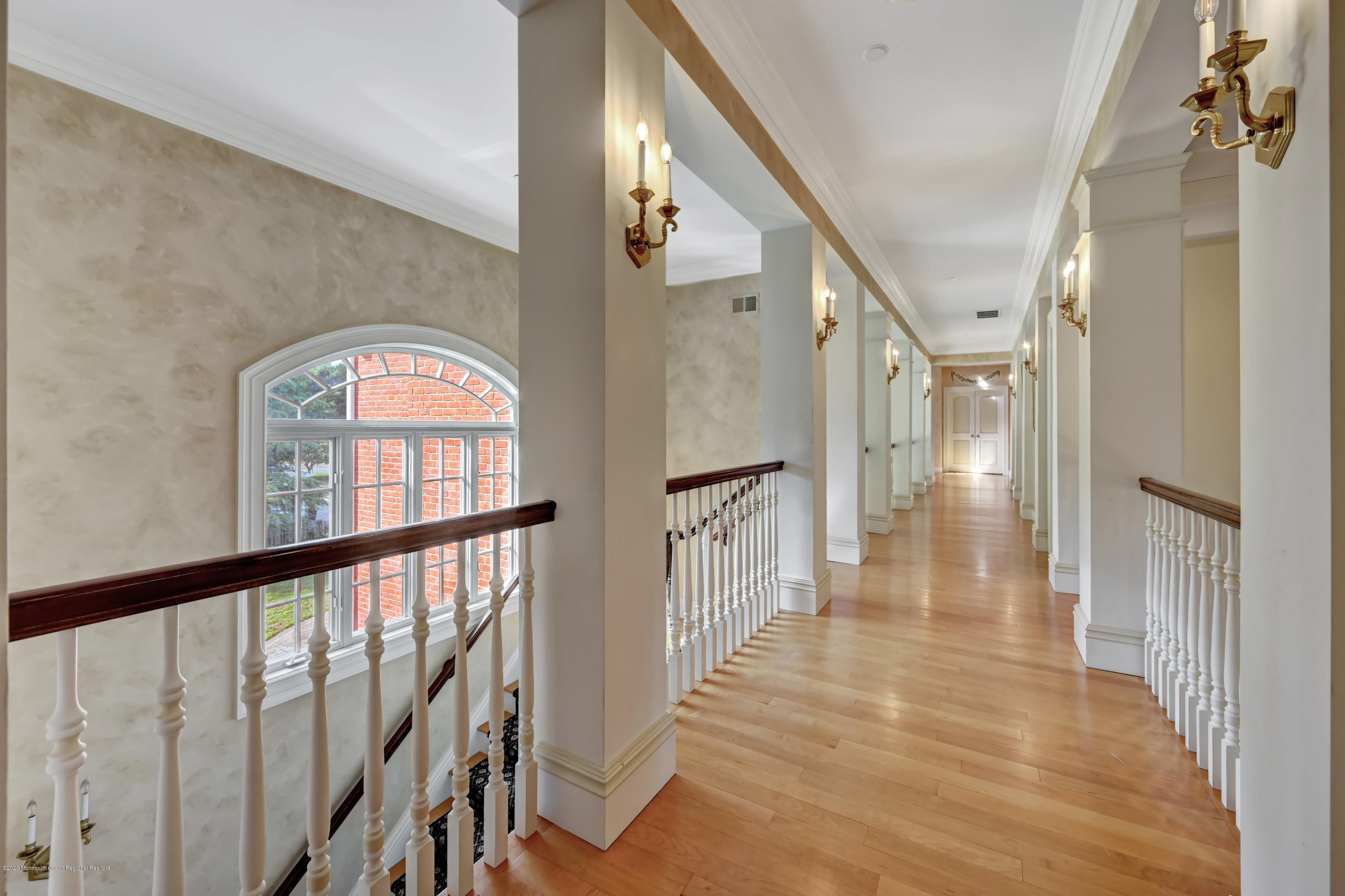 1 Laredo Drive Colts Neck, NJ 07722 - Photo 50 of 78 a view of a hallway with wooden floor and staircase