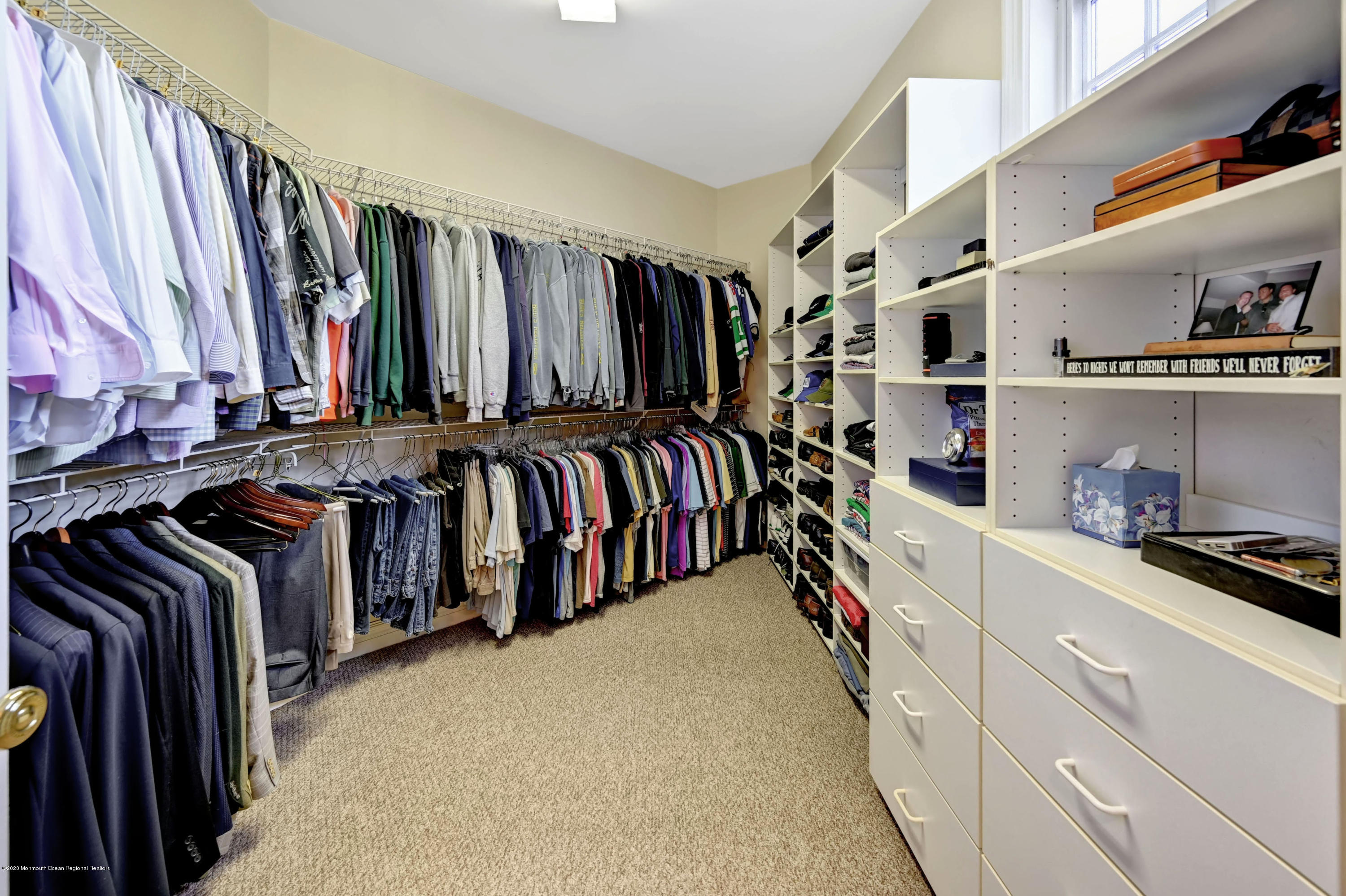 1 Laredo Drive Colts Neck, NJ 07722 - Photo 57 of 78 a view of walk in closet with clothes and shoes