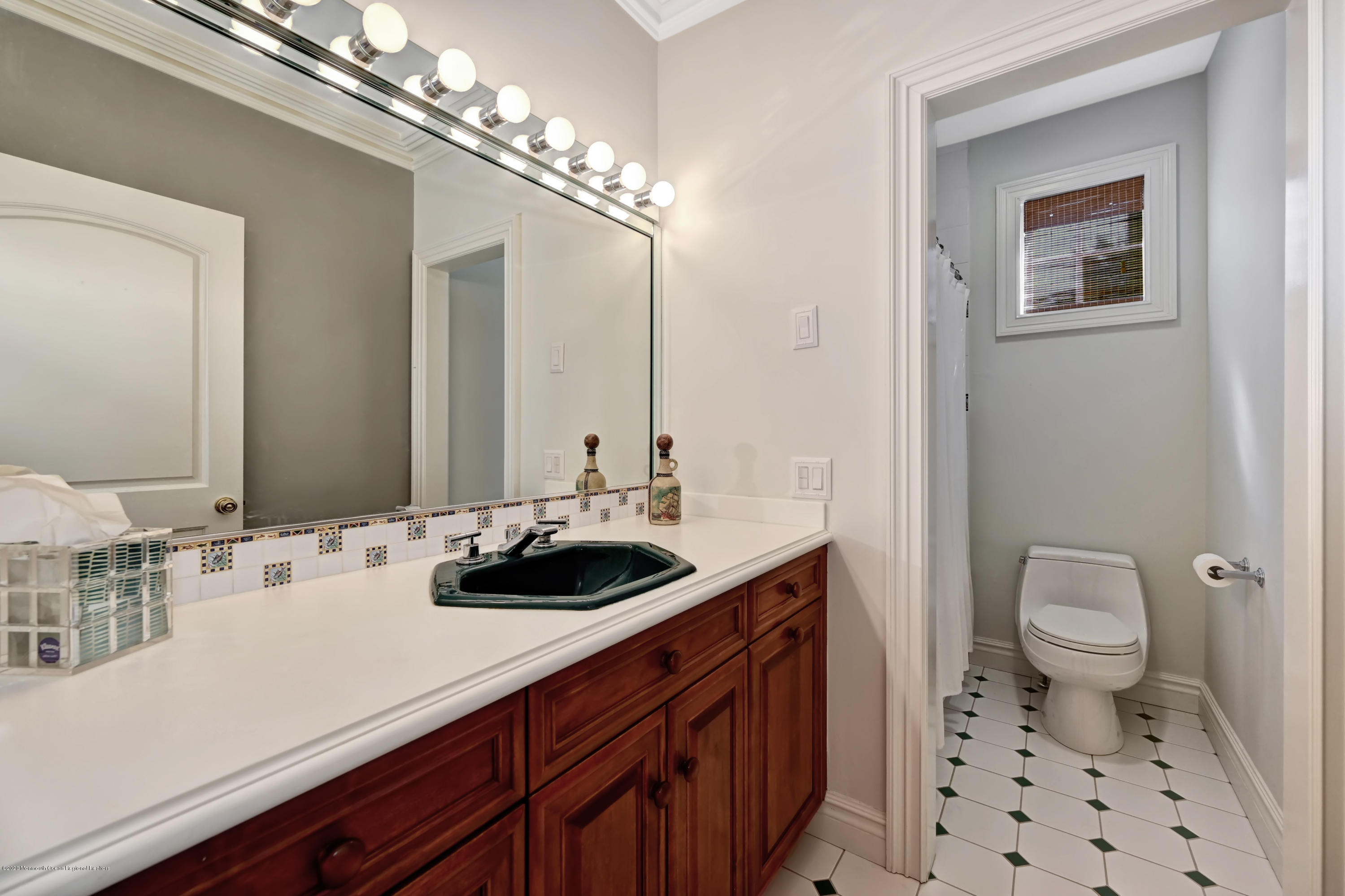 1 Laredo Drive Colts Neck, NJ 07722 - Photo 65 of 78 a bathroom with a sink a toilet and a mirror
