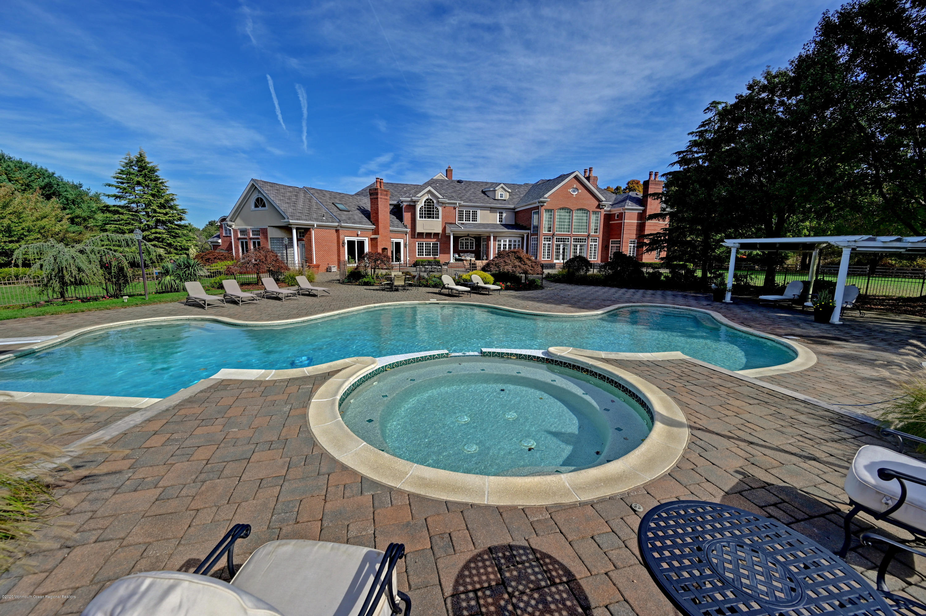 1 Laredo Drive Colts Neck, NJ 07722 - Photo 8 of 78 a front view of a house with swimming pool having outdoor seating