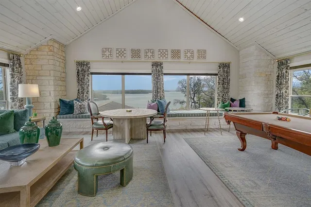 a living room with fireplace furniture and a large window
