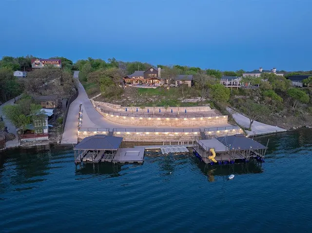 an aerial view of a house with outdoor space pool seating area