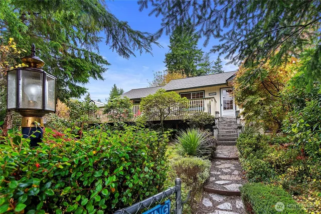a view of a house with a flower garden