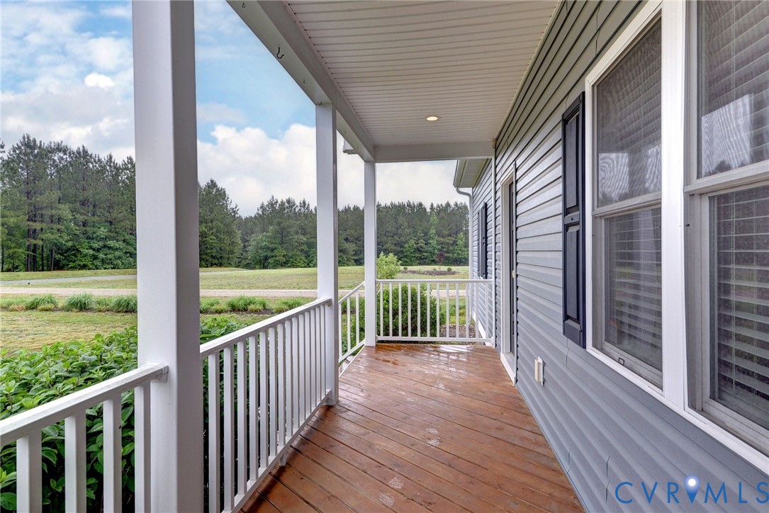 8904 Rock Cedar Road New Kent, VA 23124 - Photo 2 of 37 a view of a balcony with wooden floor