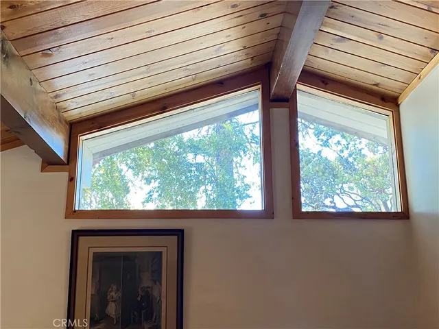 a bedroom with a bed and a flat tv screen on dresser
