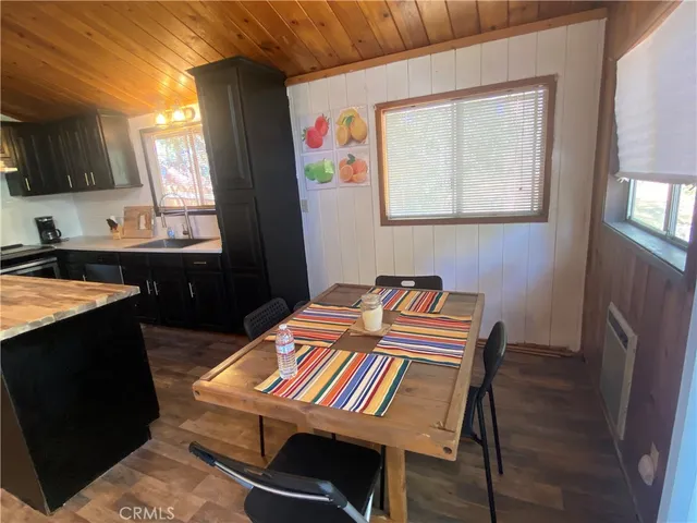 a kitchen with kitchen island granite countertop a sink and a window