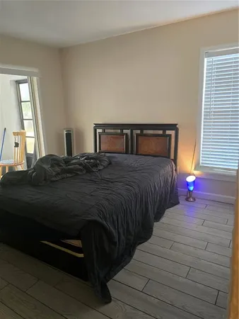 a bedroom with a bed a closet and a window