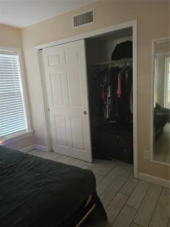 a bedroom with a bed and a closet