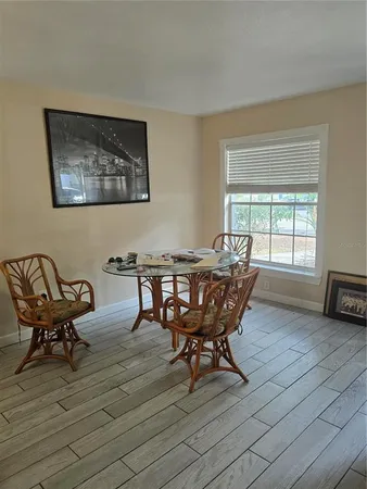 a view of a dining room with furniture and wooden floor