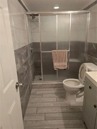 a bathroom with a toilet and a shower