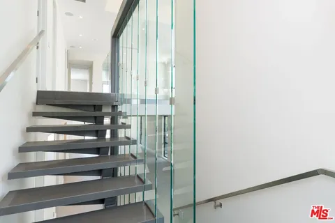 a view of staircase with white walls and a window