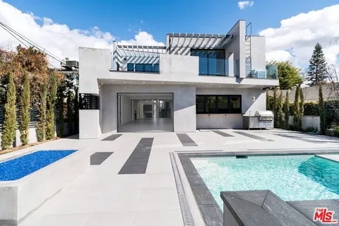 a view of a patio with couches and table and chairs