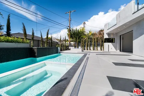 a view of a livingroom with furniture and staircase